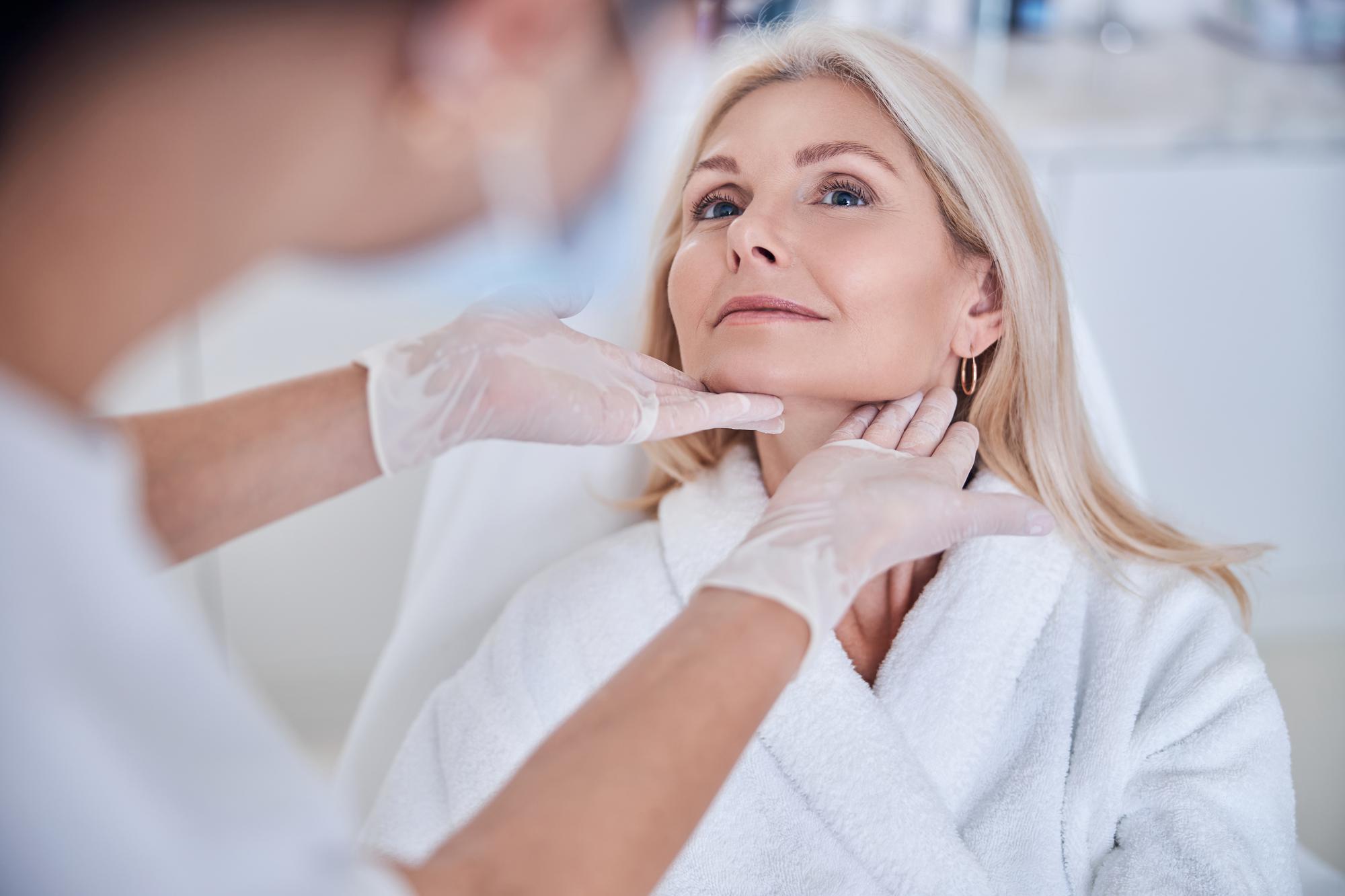 A dermatologist examining a patient's skin